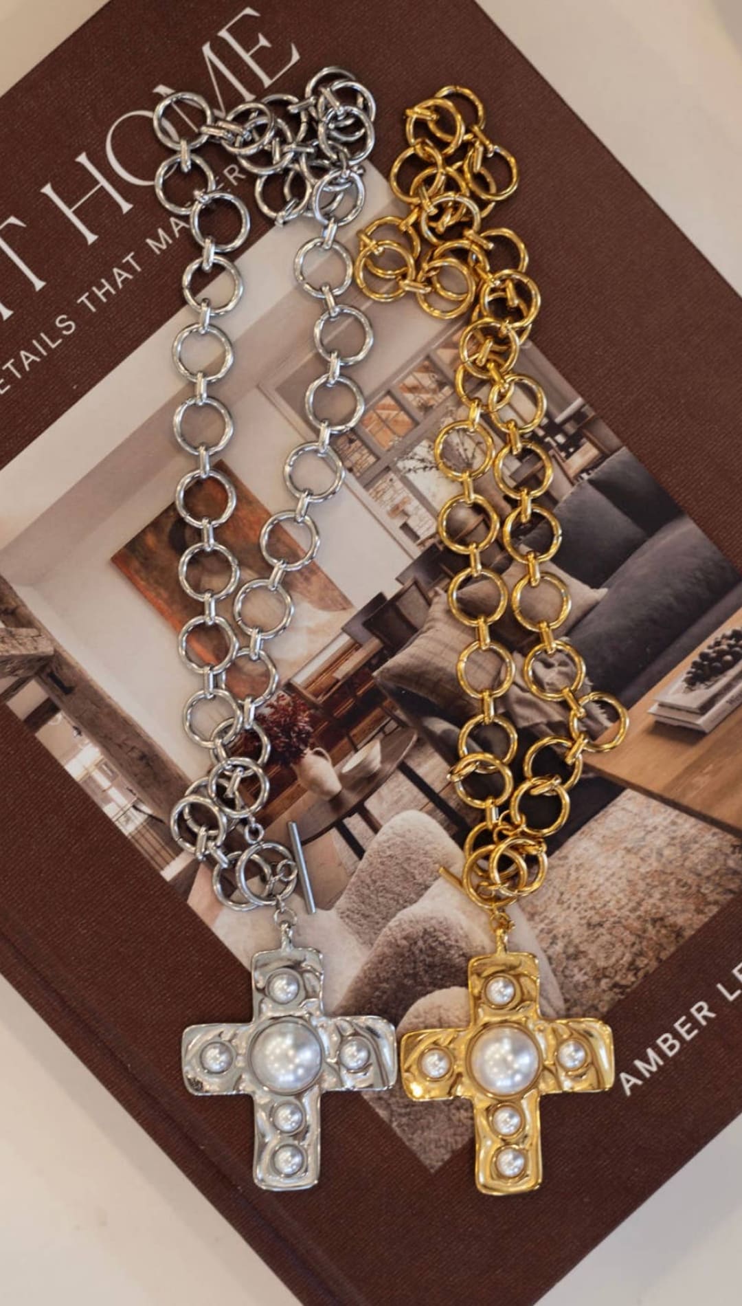 Silver and gold chain necklaces, each featuring a cross pendant adorned with pearls.