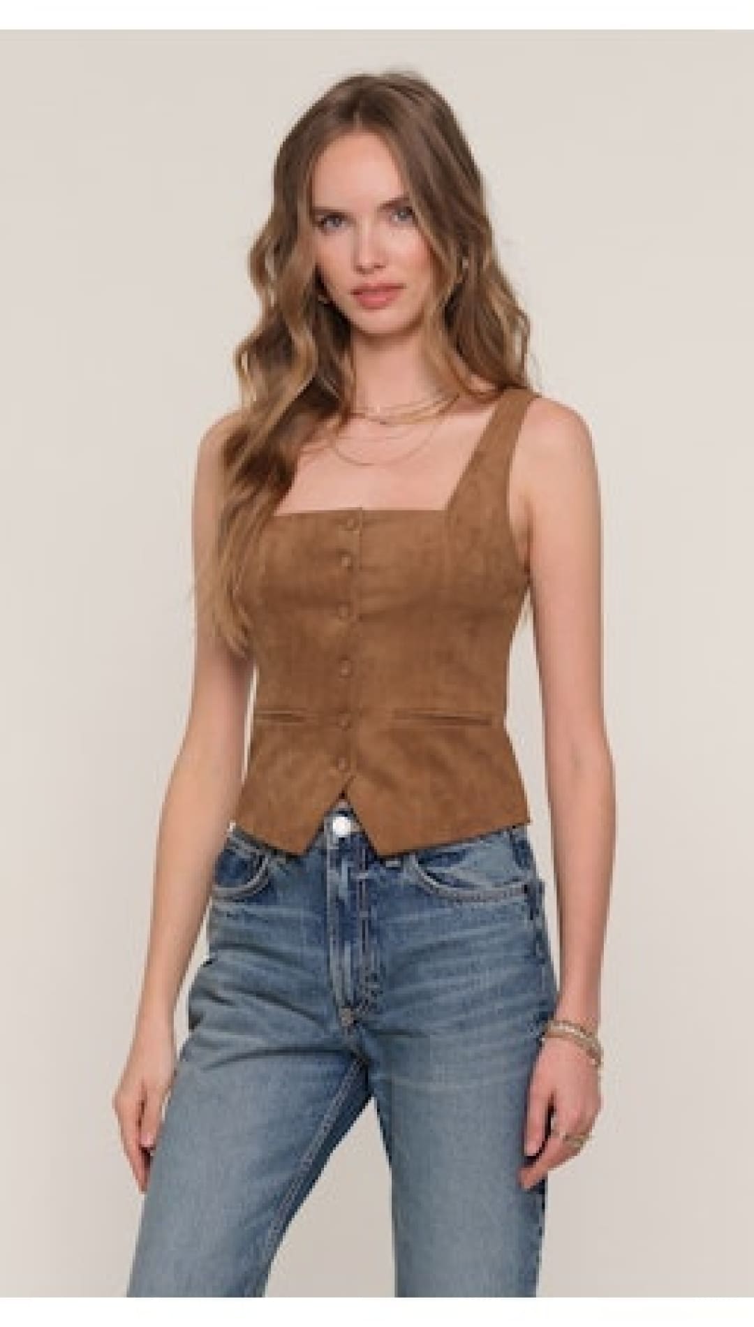 A brown suede sleeveless button-up vest.