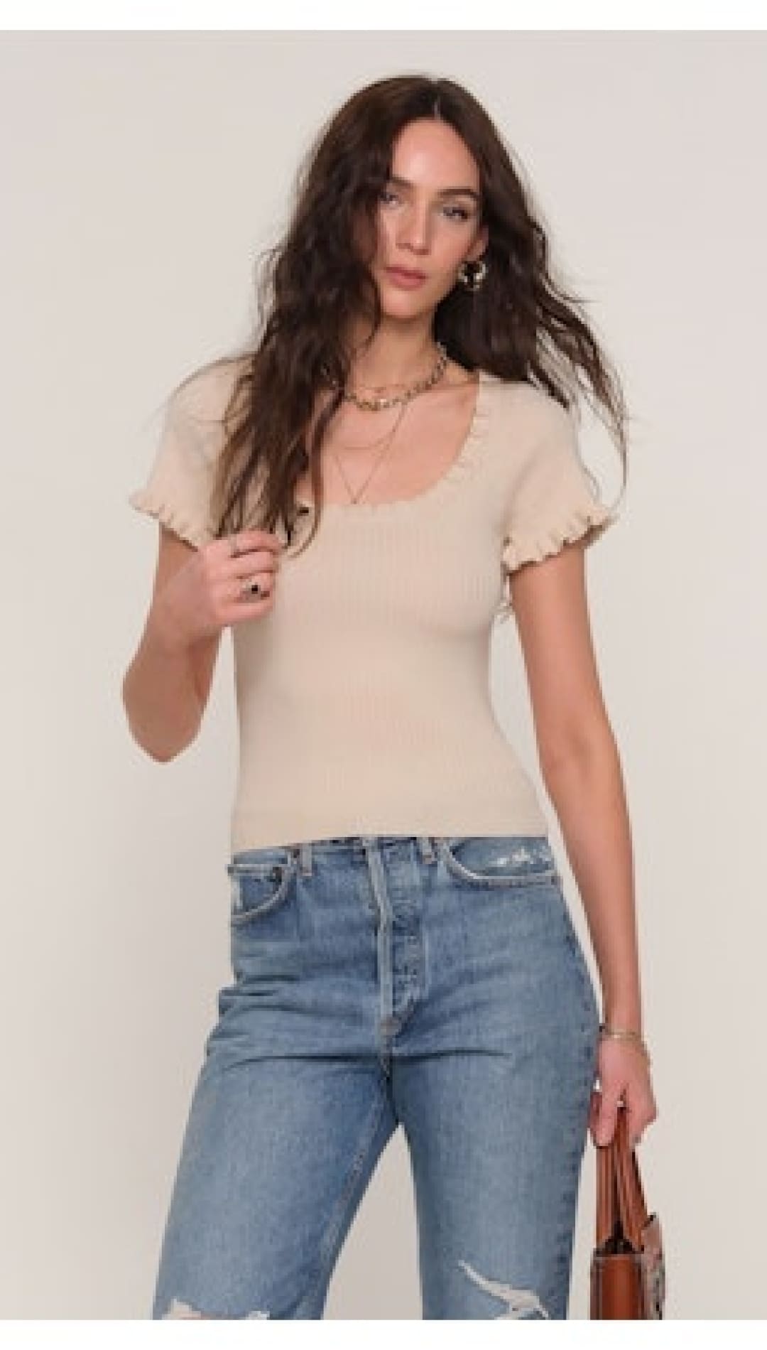 Women’s beige ribbed knit scoop neck top with ruffled short sleeves.