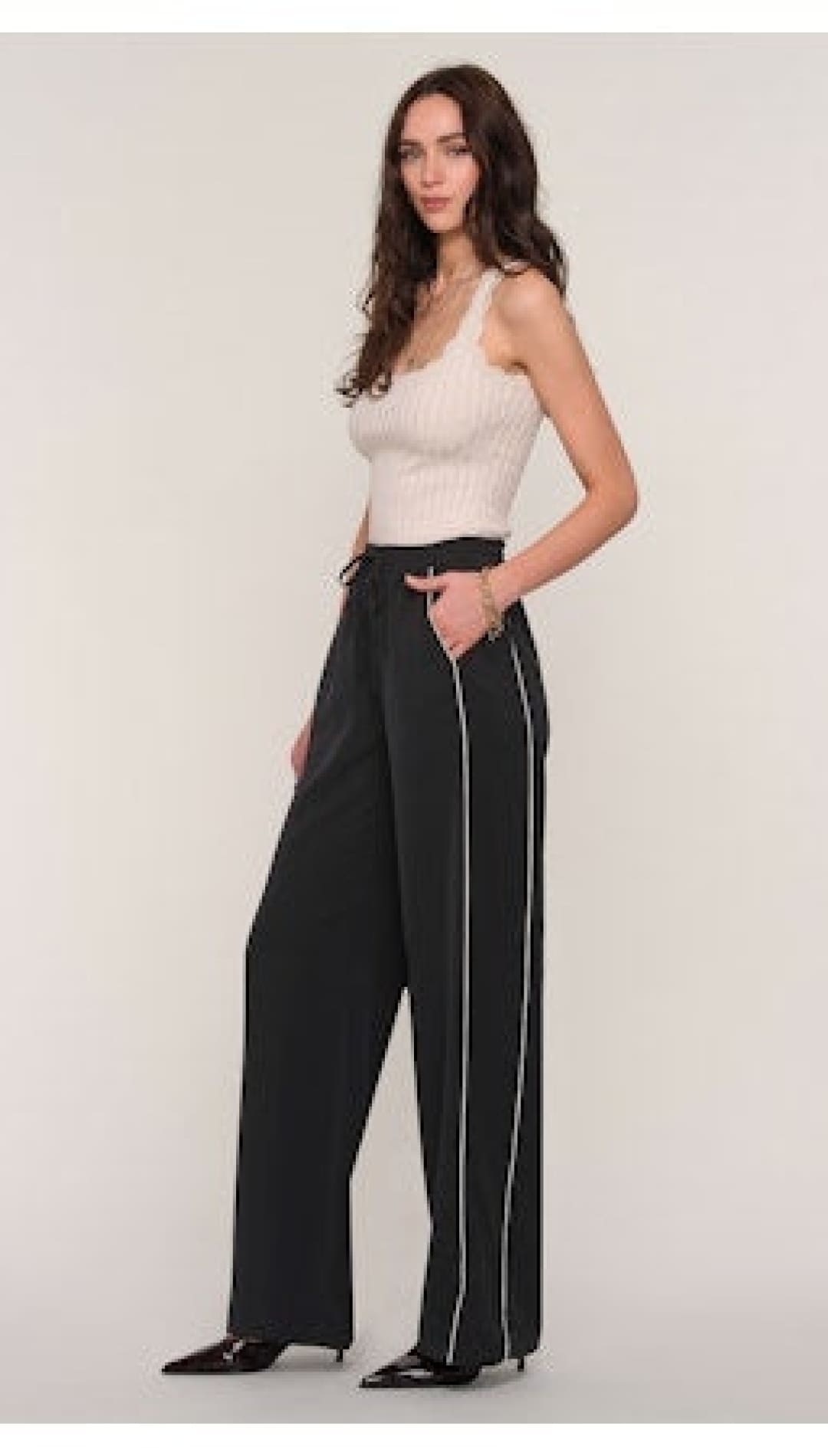 Women’s black wide-leg pants with white side stripes.