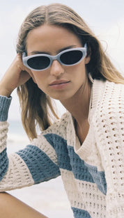 Woman wearing blue-framed sunglasses.