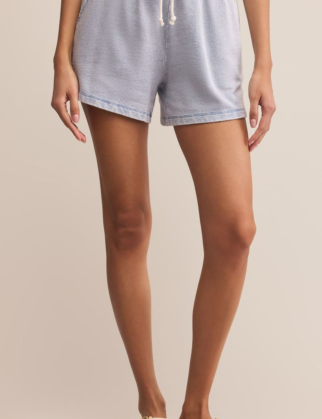 Light blue acid wash drawstring shorts with a relaxed fit.