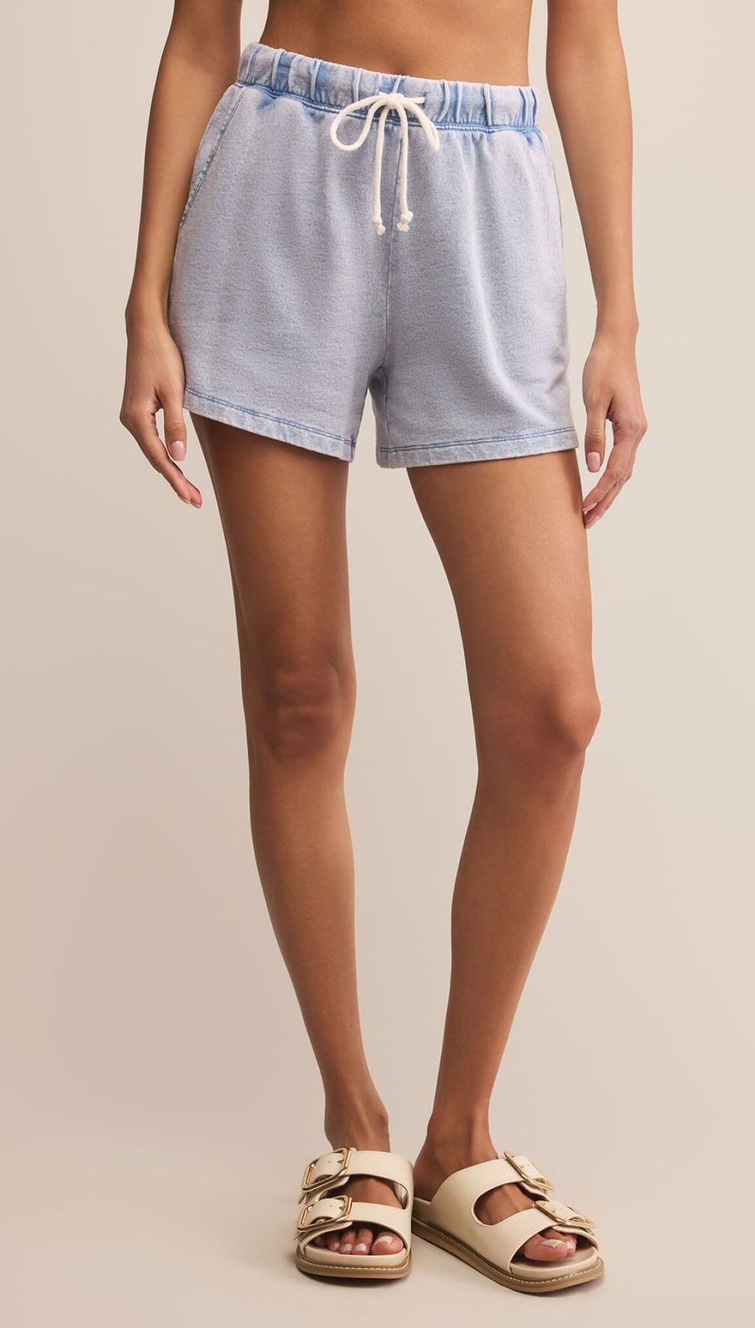 Light blue acid wash drawstring shorts with a relaxed fit.