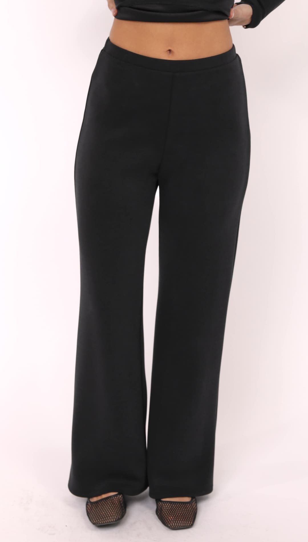 Black high-waisted flared trousers.