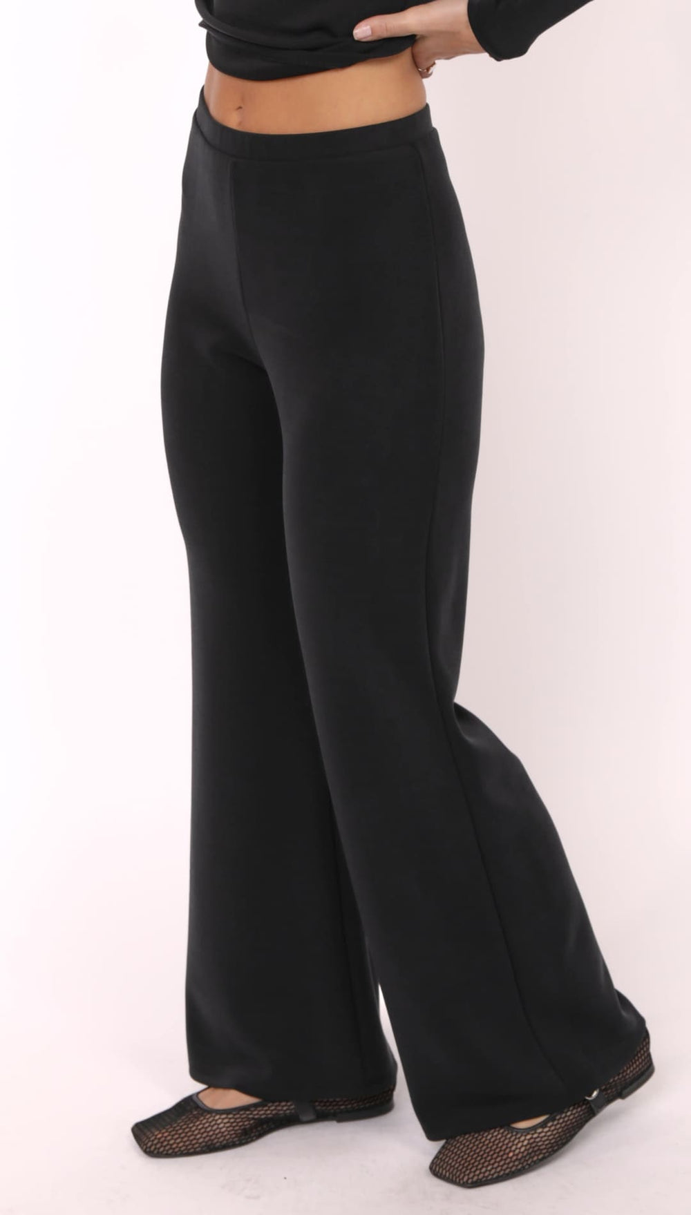 Women’s black wide-leg pants with a flat elastic waistband.