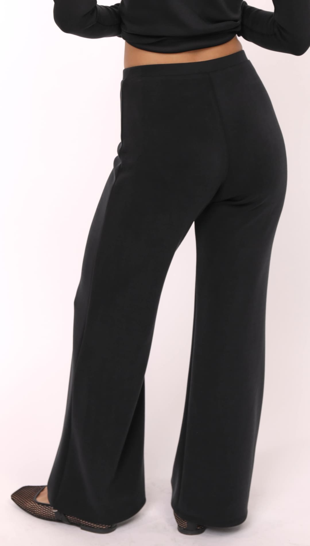 Women’s black wide-leg trousers.