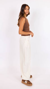 White wide-leg trousers with a high waist and front pleats.