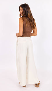 Wide-leg white trousers with a high waist and subtle pleats