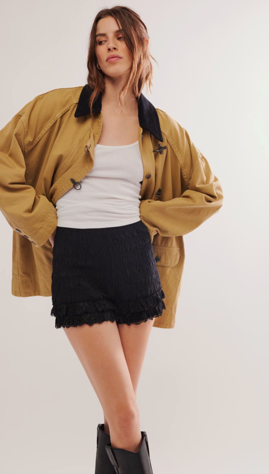 Mustard yellow oversized bomber jacket with black fur trim and button details.
