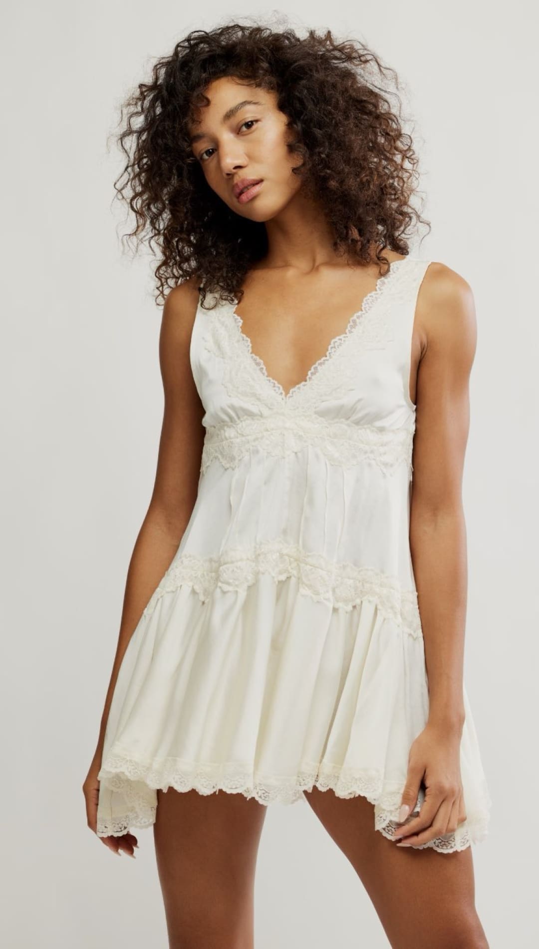 Ivory lace-trimmed mini dress.