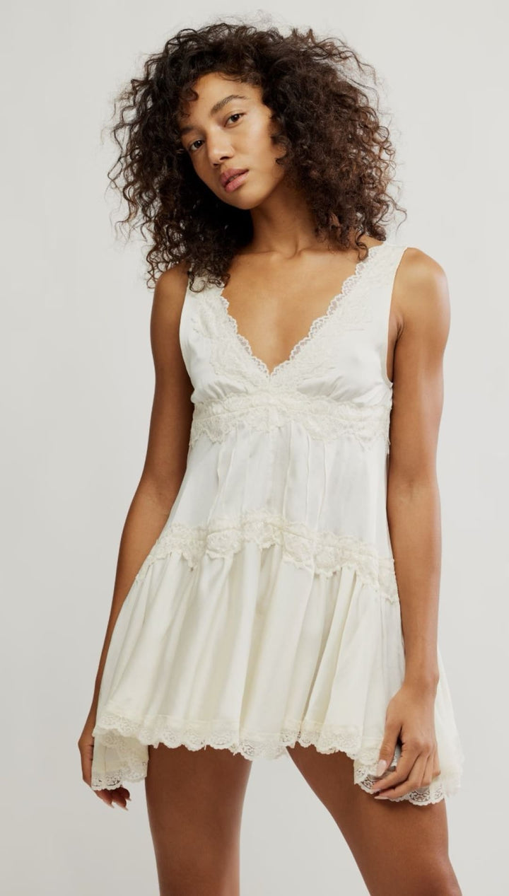 Ivory lace-trimmed mini dress.