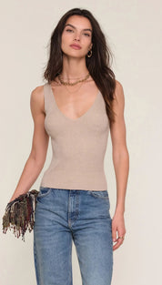 Beige sleeveless top with deep v-neck and sheer mesh panels, likely made of stretchy fabric.