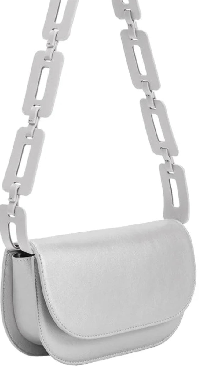 White shoulder bag with chain strap.