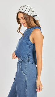 Blue denim sleeveless top with a cropped fit and front zipper detail.