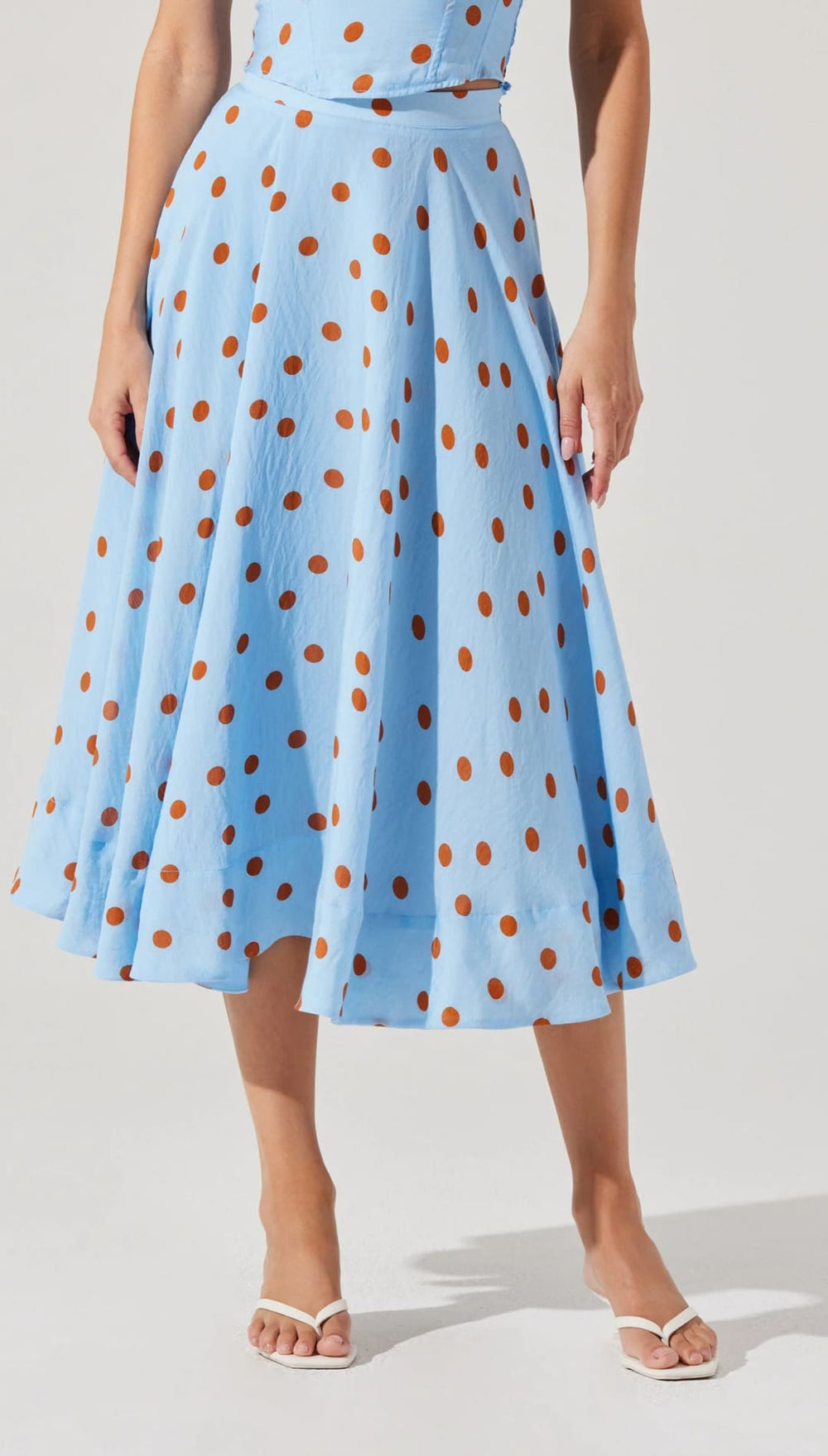 Light blue polka dot skirt.