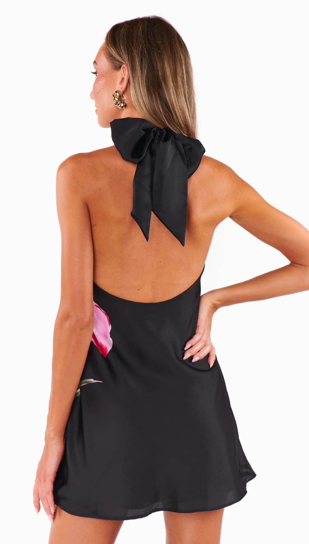 Black halter dress with floral accent.