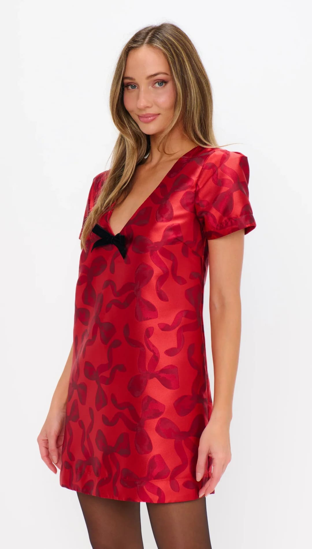 Red and black patterned dress with bow detail, short sleeves, v-neckline.