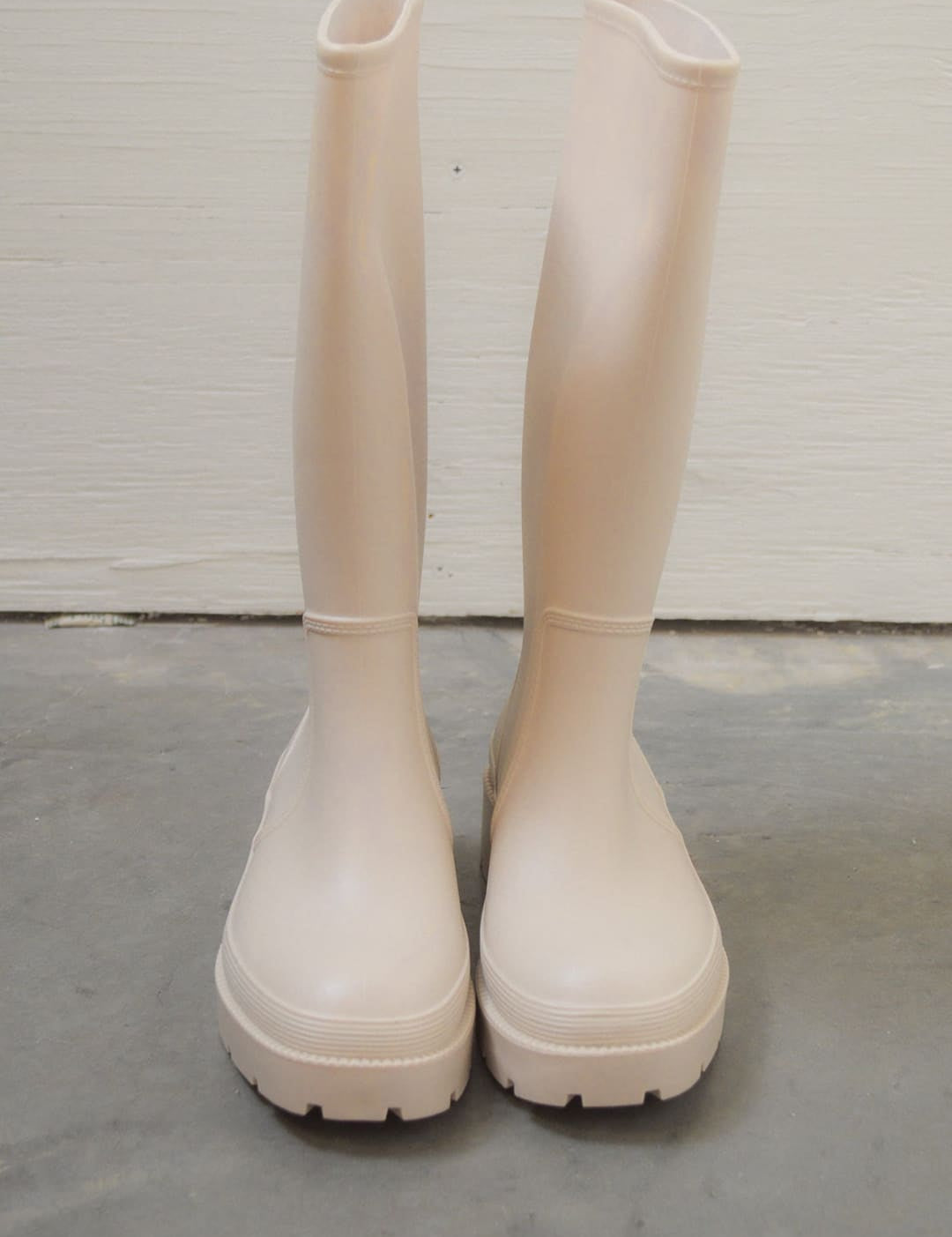 Pair of light pink rain boots.