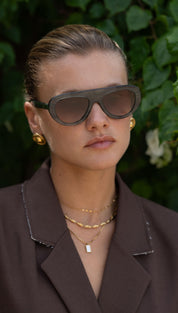 Dark gray aviator sunglasses with a sleek, modern frame and gradient brown lenses.