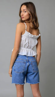 White ruffled spaghetti strap top with a peplum hemline