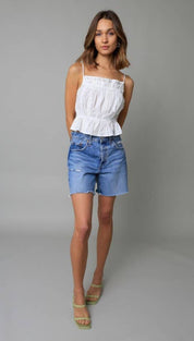 White ruffled square-necked top with thin straps and a peplum hemline.