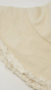 Beige bucket hat with fringed brim.