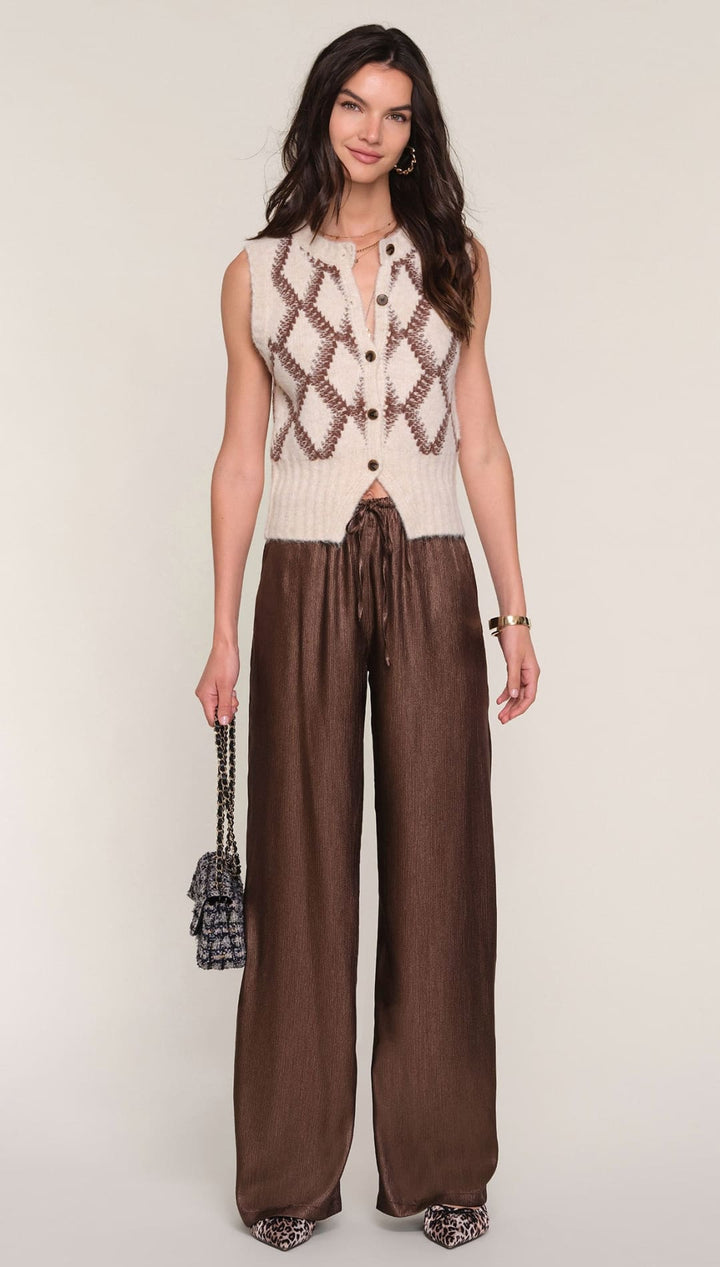 Brown wide-leg pants with drawstring waist and snakeskin heels.