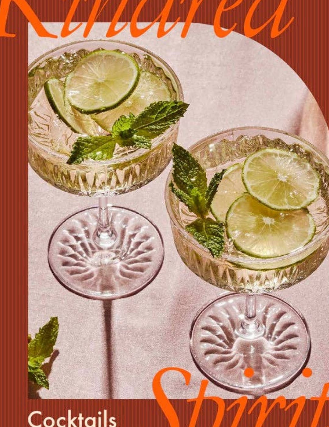 Classic crystal cocktail glasses with lime slices and mint leaves, set against a warm brown background.