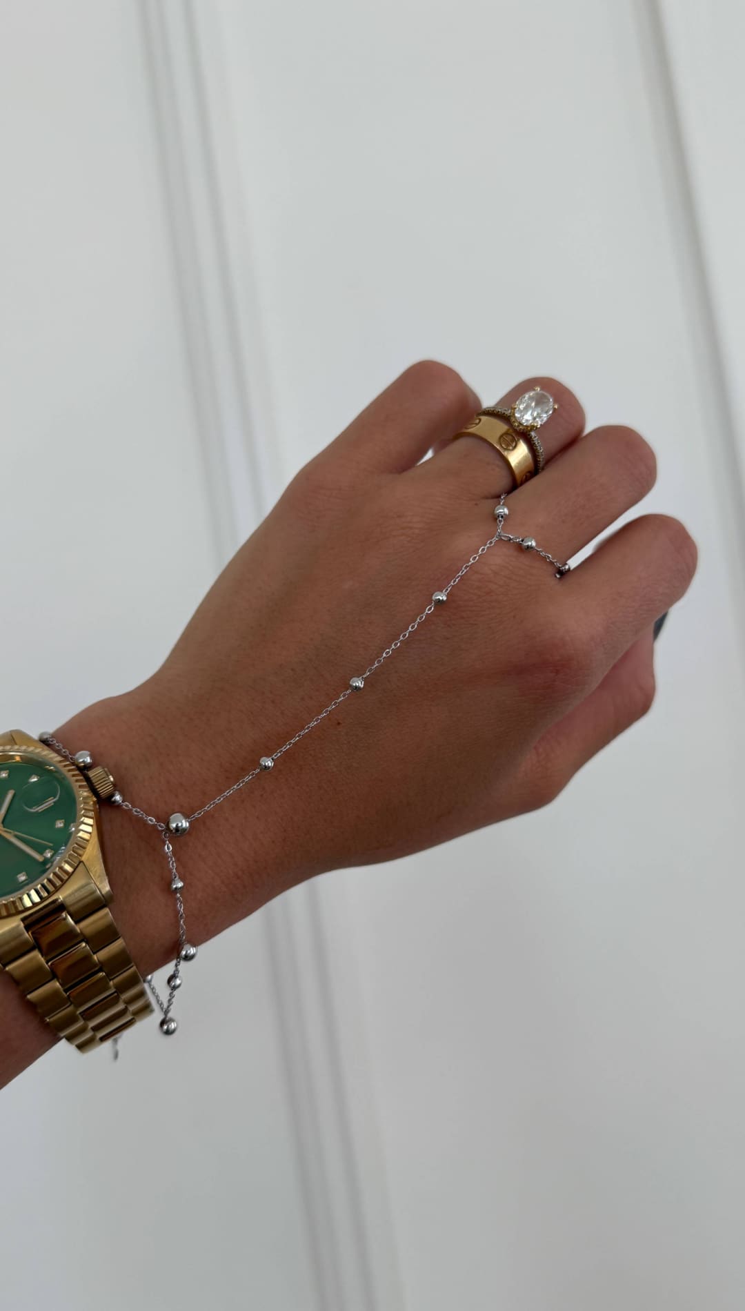 Gold-tone rolex watch with a vibrant green dial and fluted bezel, paired with a matching gold bracelet.