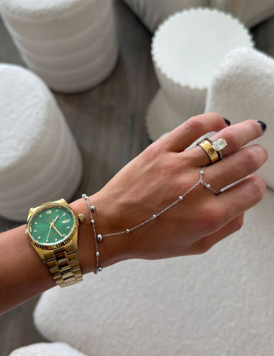 Gold-tone wristwatch with a vibrant green dial and classic roman numerals.