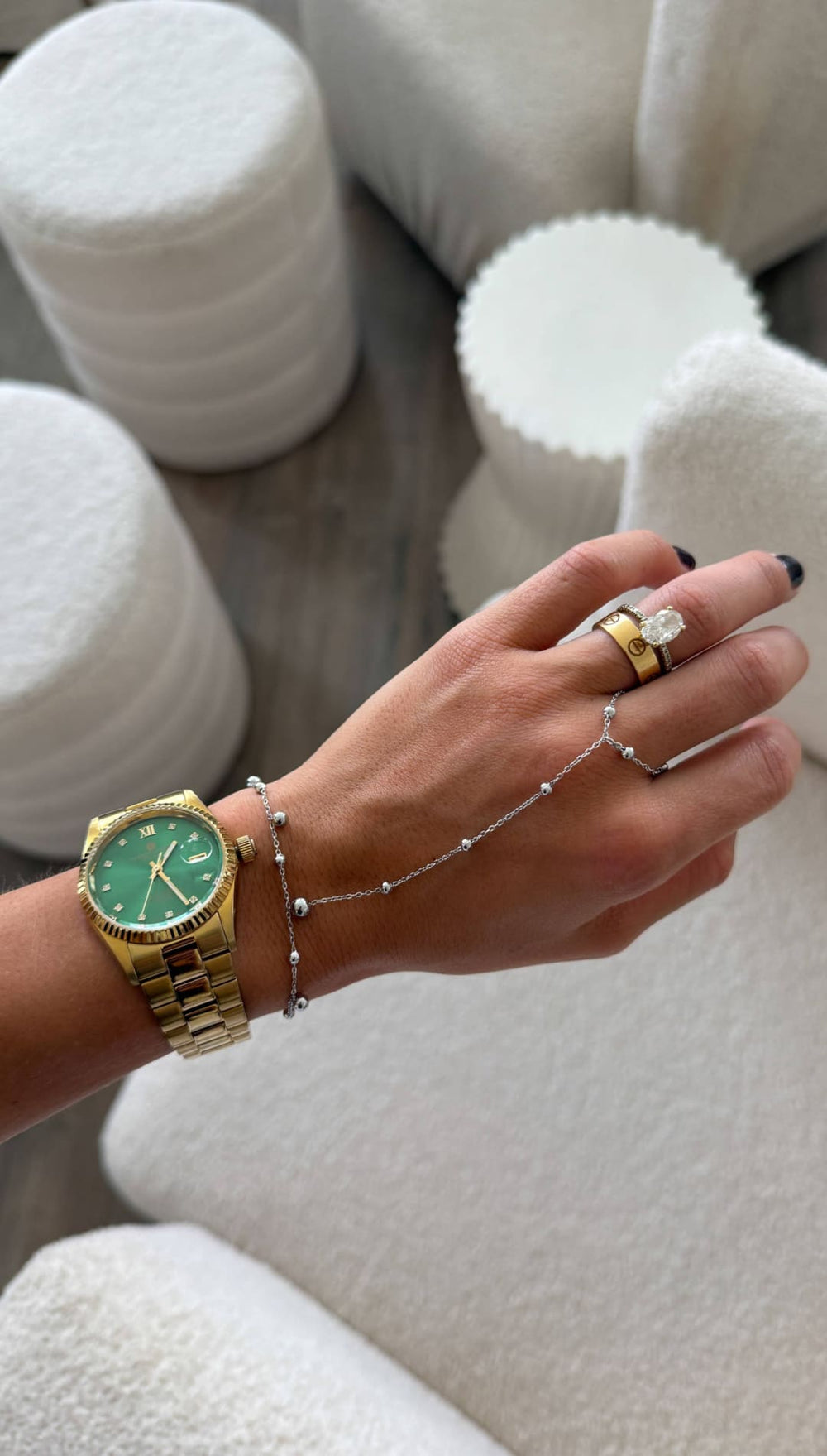 Gold-tone wristwatch with a vibrant green dial and classic roman numerals.