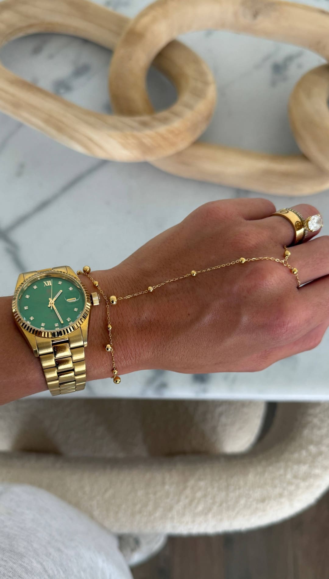 Gold-tone wristwatch with a vibrant green dial and roman numeral hour markers, featuring a classic link bracelet design.