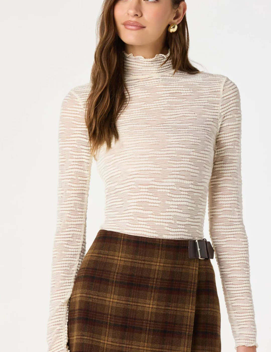 Beige textured long-sleeve turtleneck top with subtle horizontal ribbing.