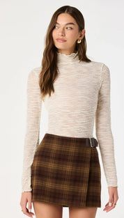Beige textured long-sleeve turtleneck top with subtle horizontal ribbing.