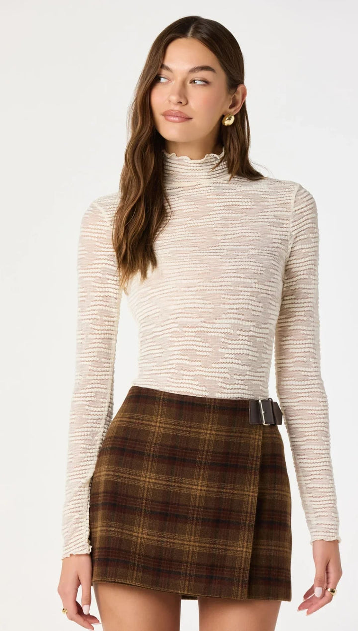 Beige textured long-sleeve turtleneck top with subtle horizontal ribbing.