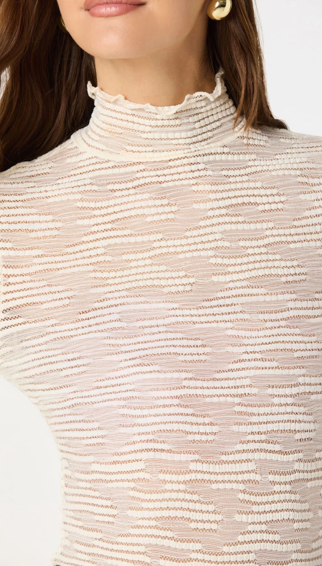 A delicate off-white, ribbed knit top with a high neckline and subtle horizontal texture.