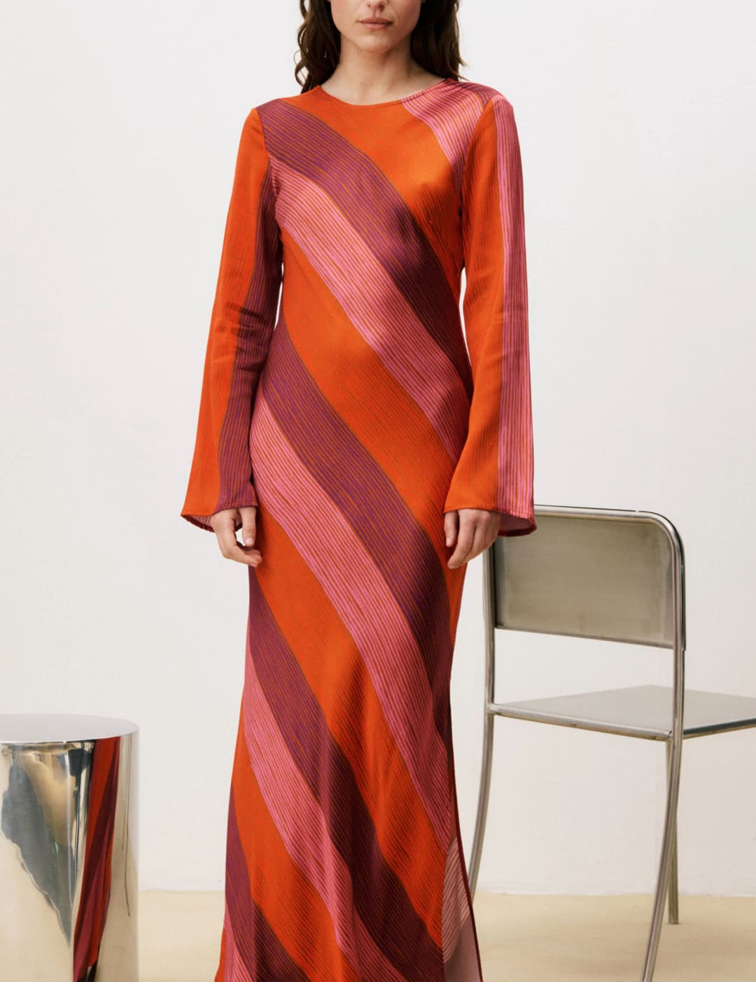 Orange and pink striped maxi dress with bell sleeves.