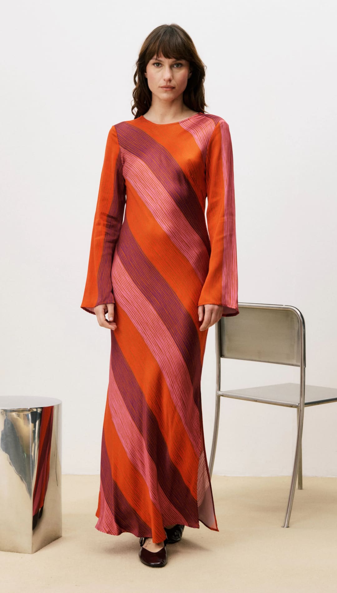 Orange and pink striped maxi dress with bell sleeves.
