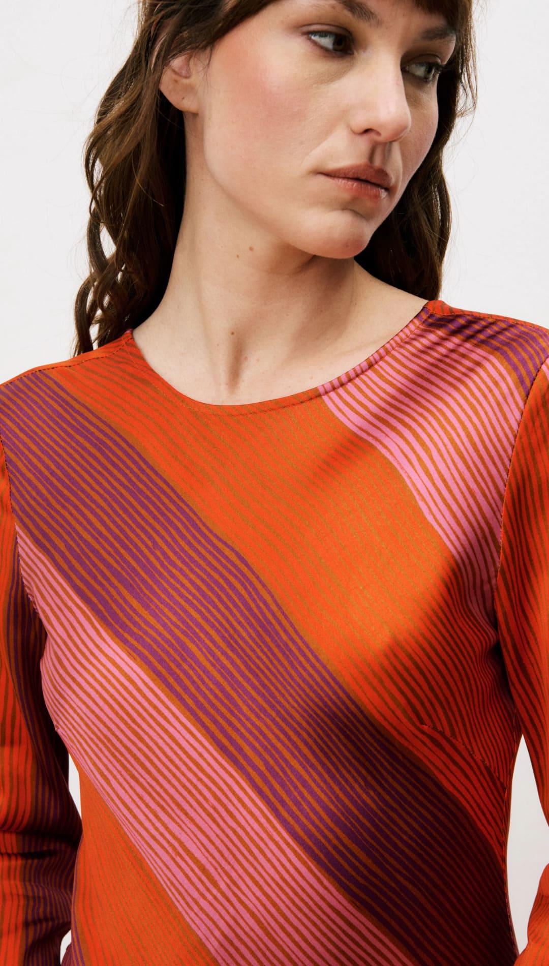 Orange and pink striped sweater with ribbed texture.