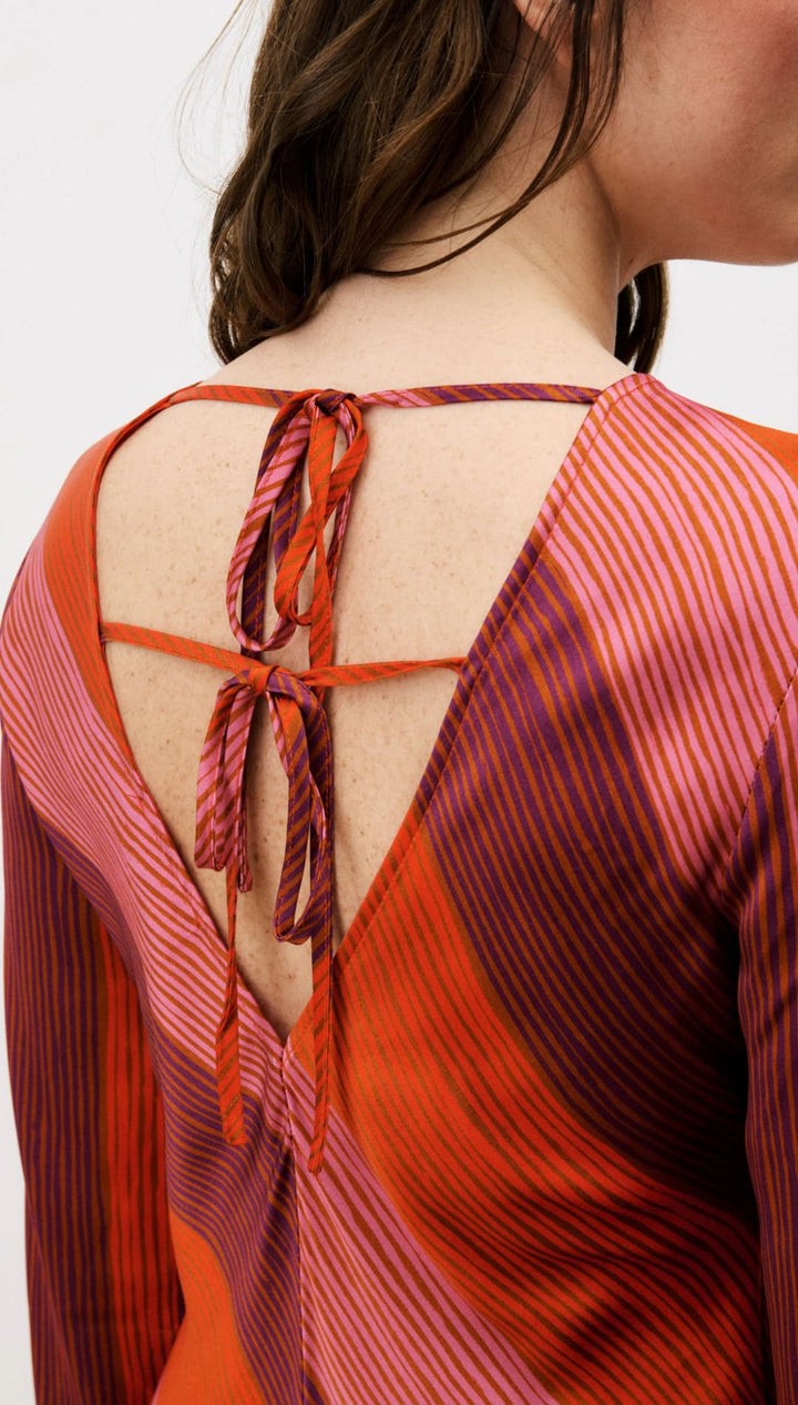 Orange and red striped blouse with lace-up back detail.