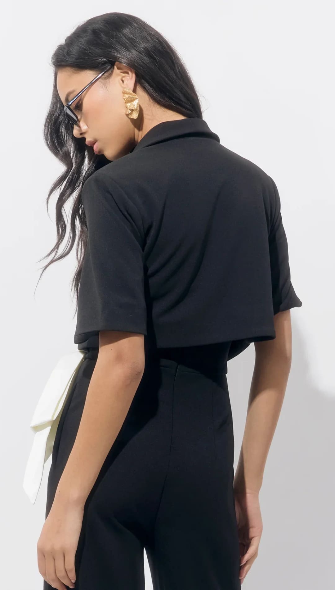 Women’s black short-sleeved collared crop top.