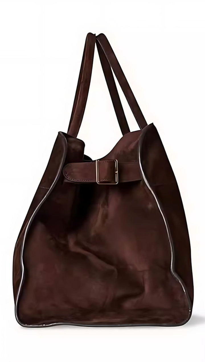 Brown leather tote bag with a buckle detail and long handles.