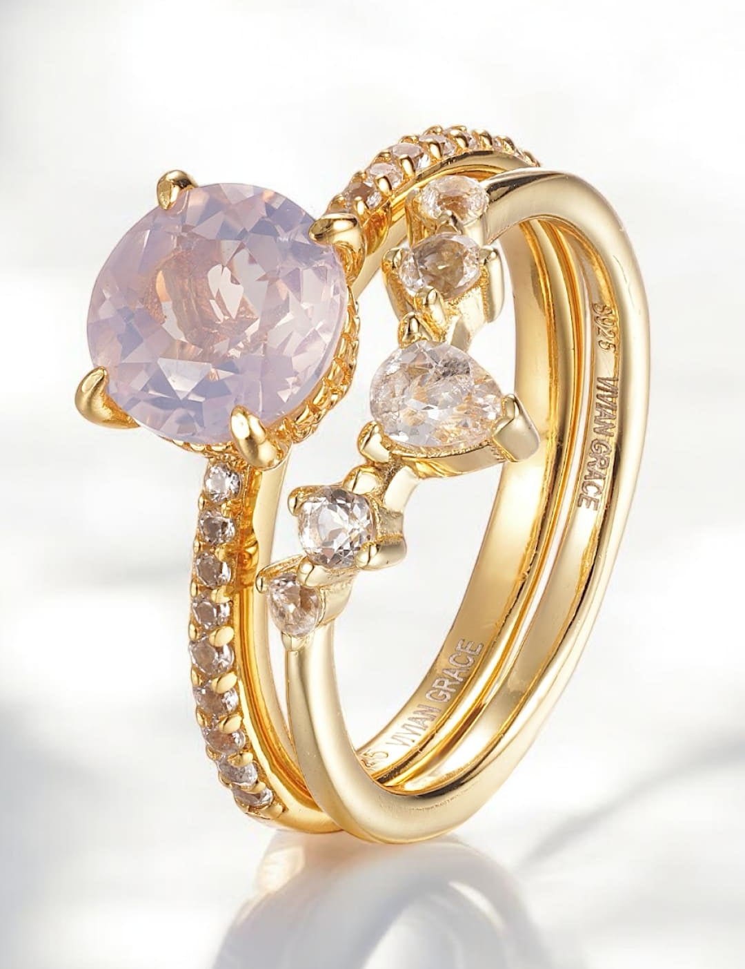 Gold ring set with pink gemstone and diamonds.