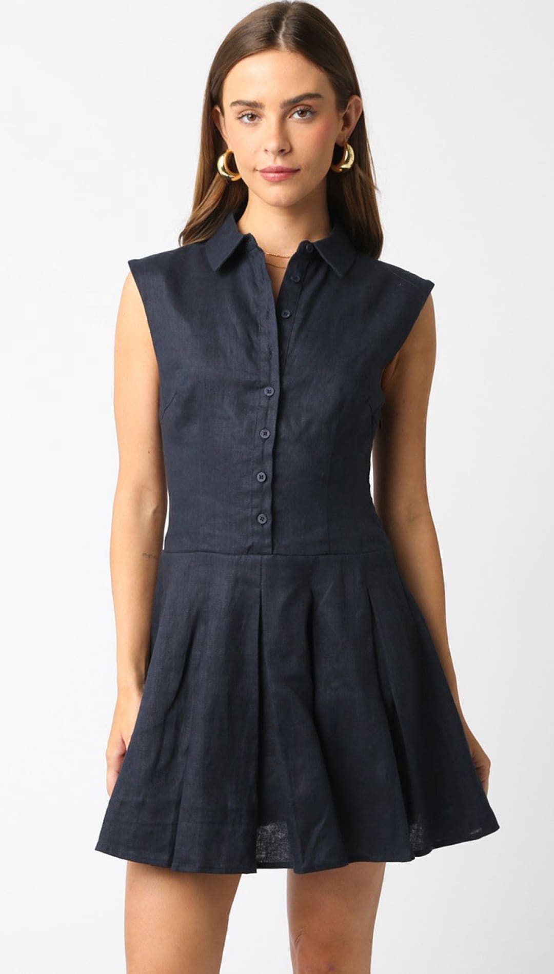 Sleeveless navy collared dress.