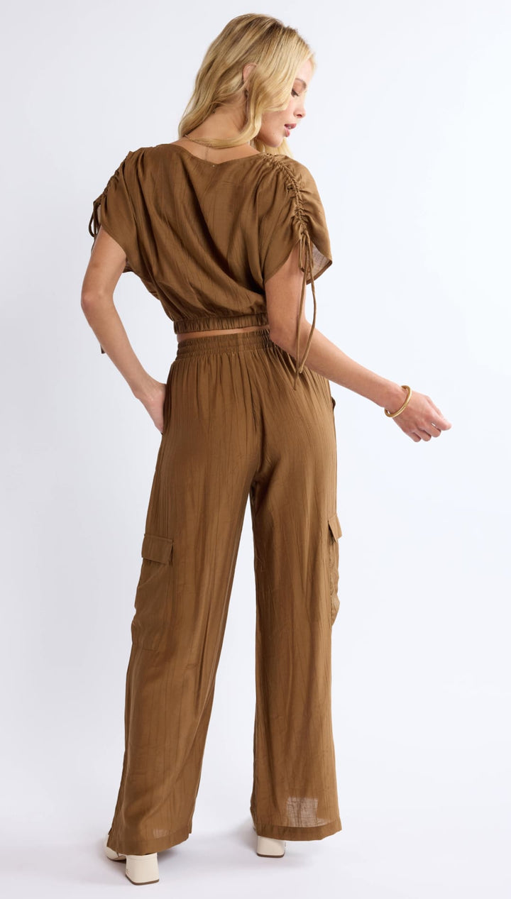 Brown two-piece crop top and cargo pants set.