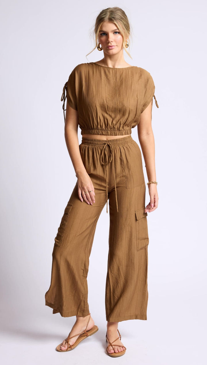 Brown linen crop top and wide-leg pants set.