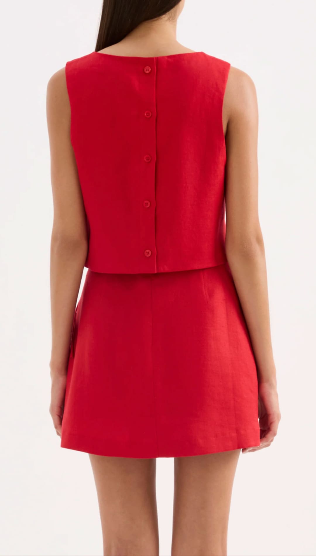 A vibrant red sleeveless dress with a buttoned back and flared skirt.