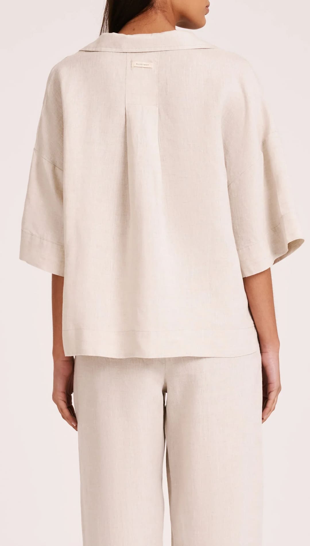 Beige linen shirt and pants set.