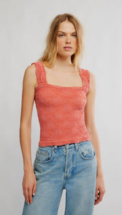 Coral-colored lace tank top with a square neckline and delicate floral pattern