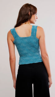 A teal, intricately patterned knit top with a square neckline and thin straps.